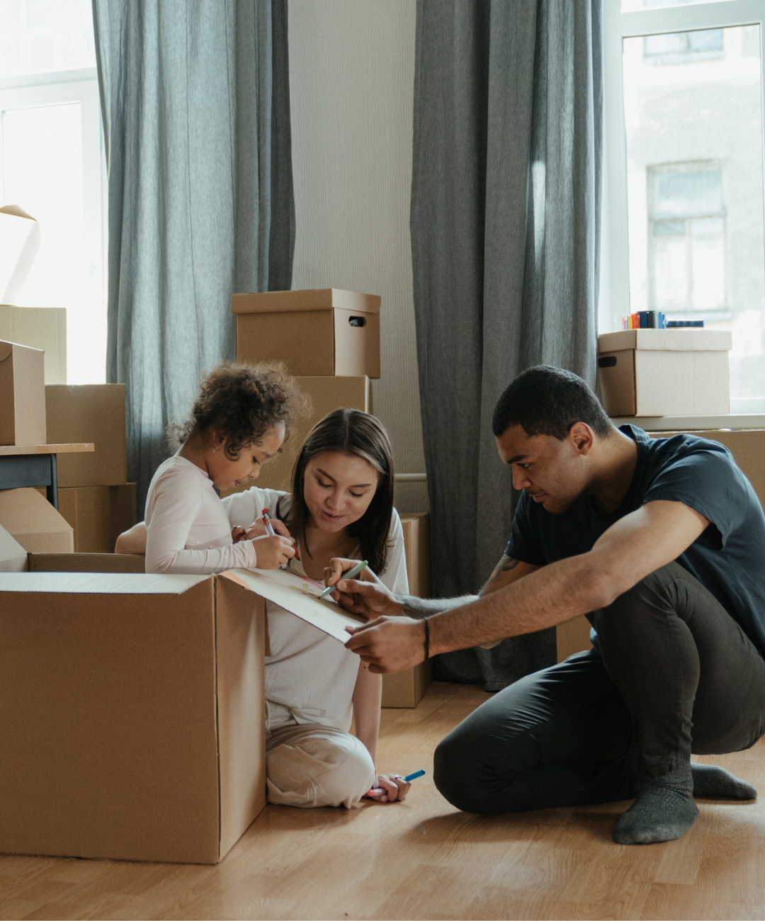 <img src=“family unpacking.png” alt=“African American family unpacking boxes while sitting on the floor together”>