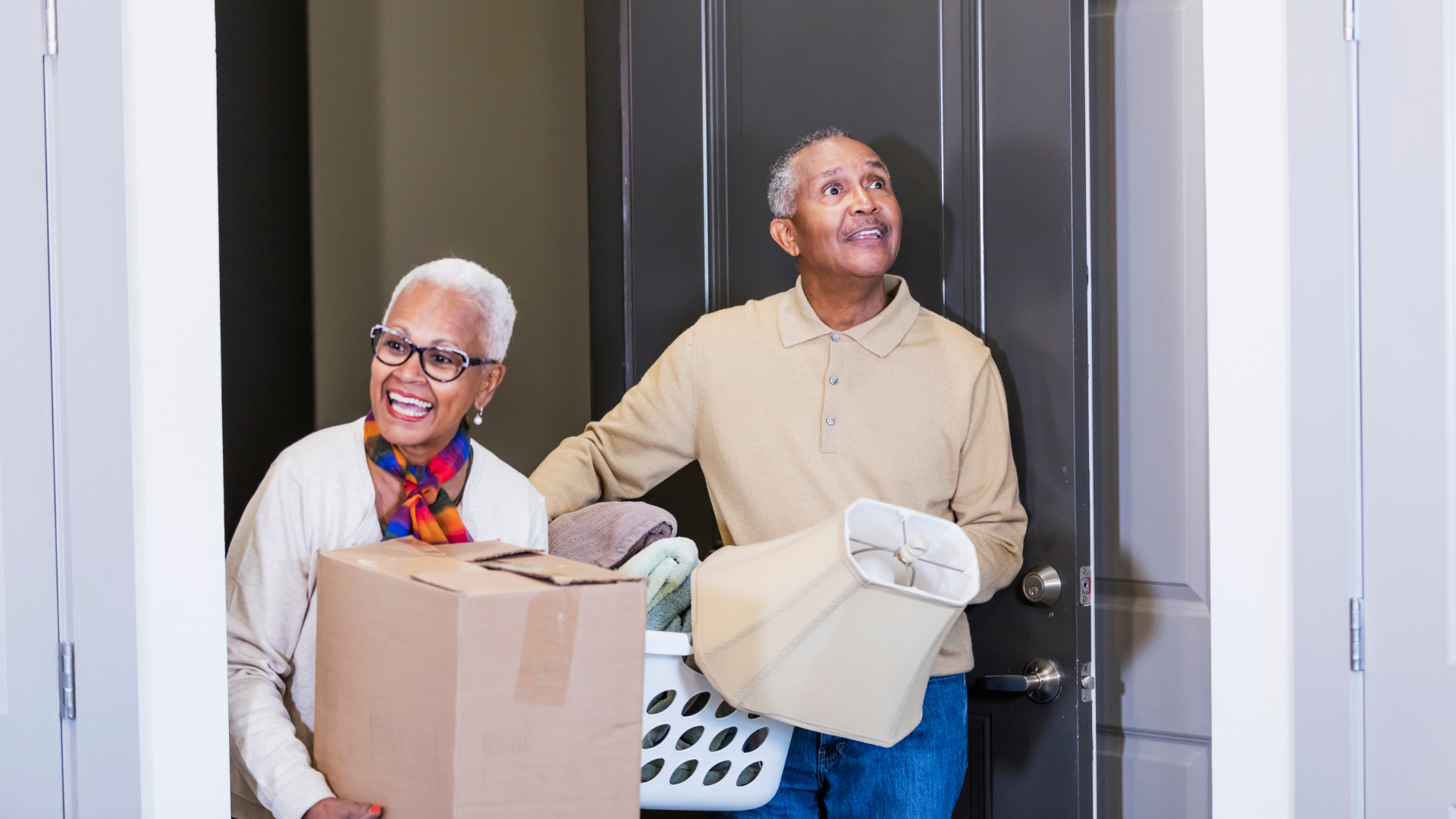 Senior couple carrying their box of stuff ready for a move