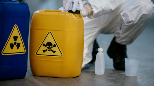 2 hazardous containers being checked by a guy