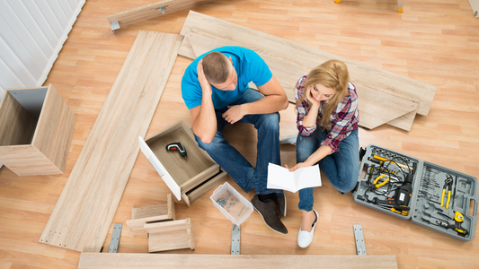 Couple with disassembled furniture