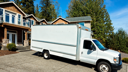 Plain white moving truck in driveway