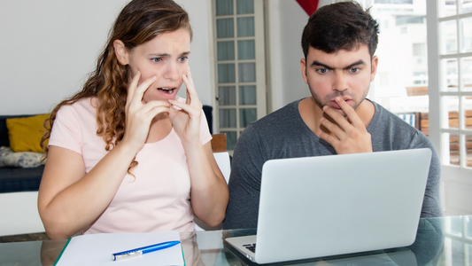 Shocked couple in front of the laptop