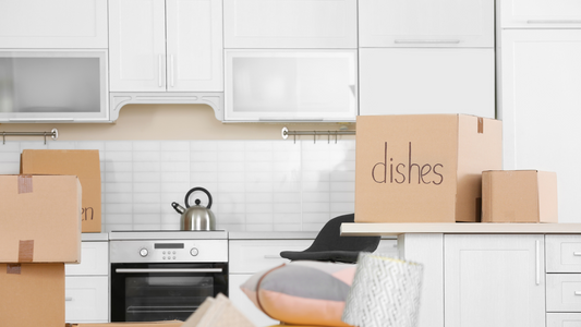 Cardboard boxes and household stuff in kitchen moving day