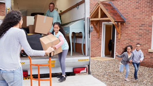 Family unloading furniture from moving truck