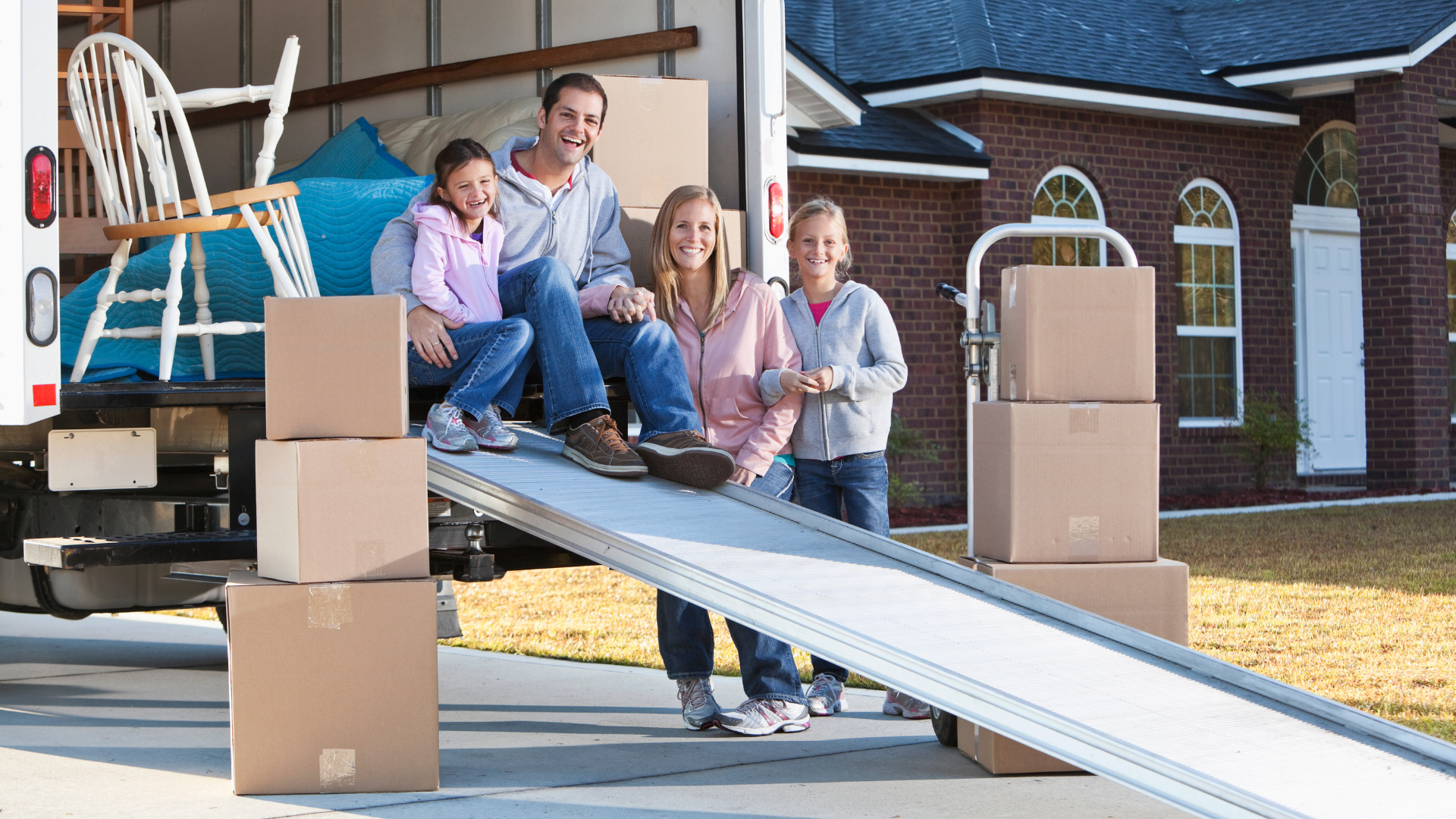 A family moving all the stuff from their old place, all the stuff are placed inside the truck. 