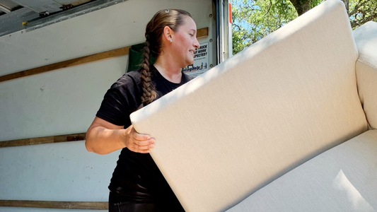 <img src=“loading couch into truck.png” alt=“woman loading a couch into a uhaul truck”>