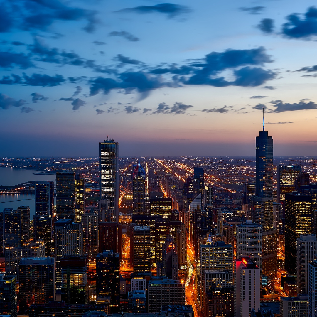 alt="A stunning view of the Chicago skyline illuminated at dusk"