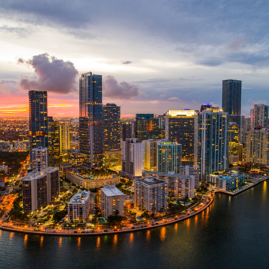 alt="Dusk aerial view of Miami, highlighting the city skyline"