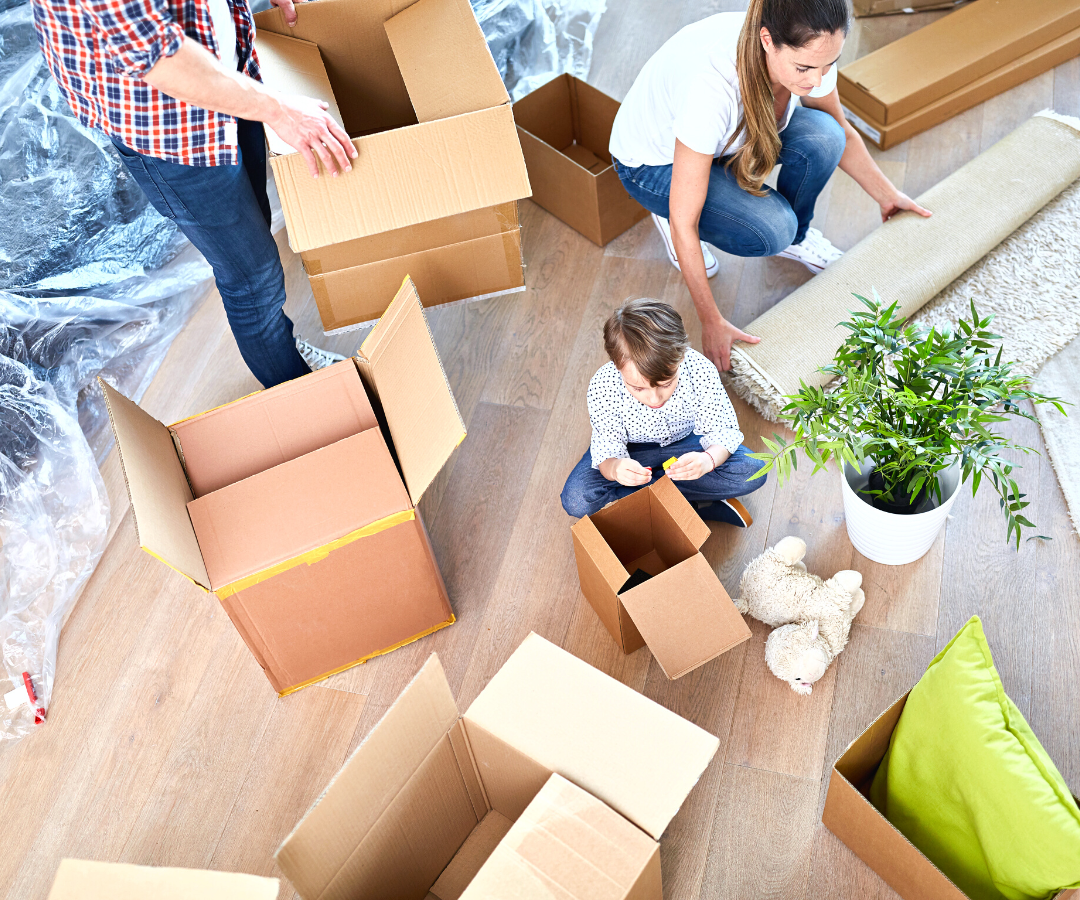 Aerial view of a family unpacking their moving boxes after finishing a successful move